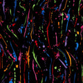 Paint splatters and drops in orange lime green blue red purple magenta on black fabric for modern quilts and patchwork sewing projects