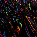 Paint splatters and drips in orange lime green blue red purple magenta on black fabric for modern quilts and patchwork sewing projects