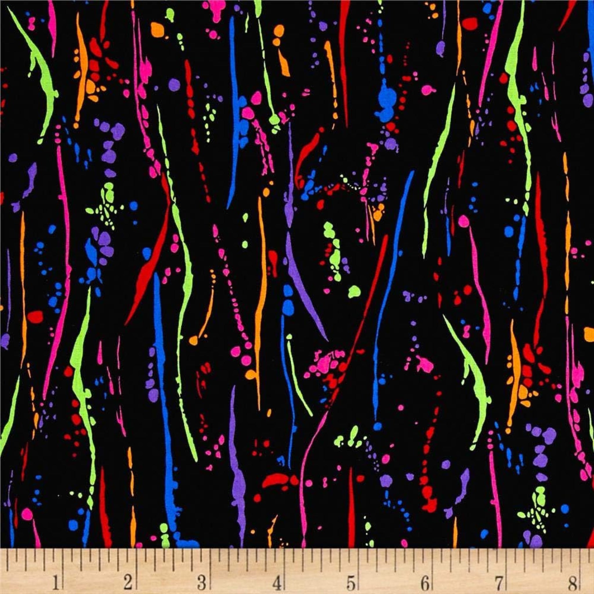 Rainbow paint splatters on black fabric for modern quilts and patchwork sewing projects