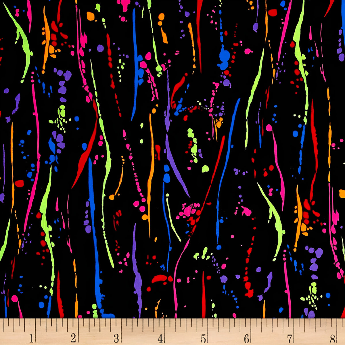 Rainbow paint splatters on black fabric for modern quilts and patchwork sewing projects