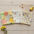 Susybee Sweet Bees fabrics with bees flowers gingham hexagons and bee sayings in yellow and green for quilting and patchwork sewing projects