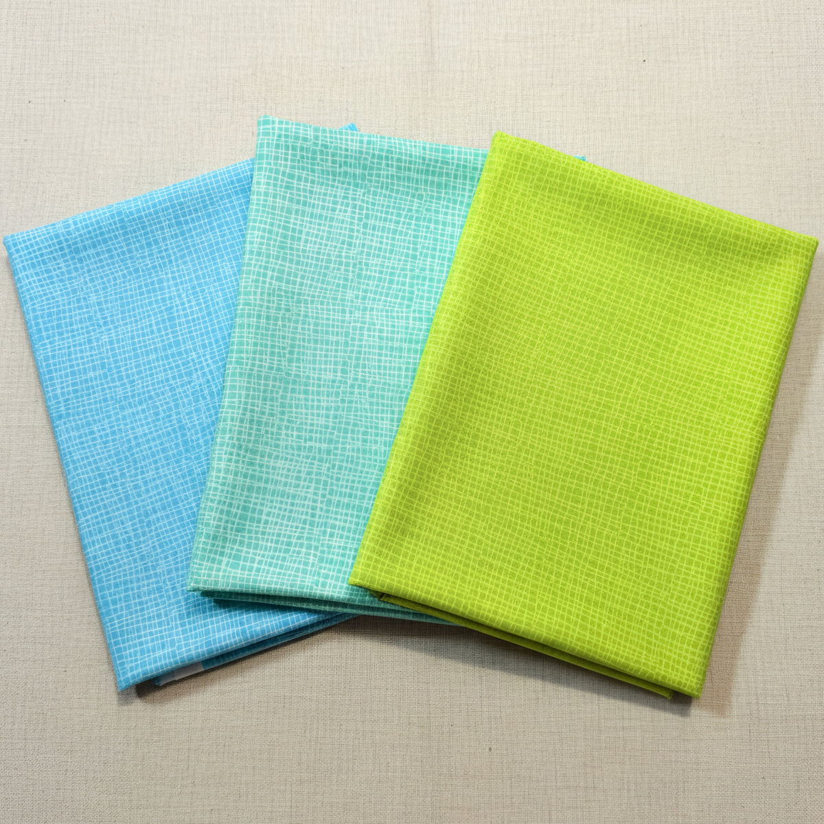 Blue turquoise jade lime green crosshatch tonal blender quilting fabric coordinates for patchwork backgrounds and sashing