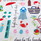 Vintage beach icons bicycles swimsuits sunglasses crabs life rings script phrases light grey novelty quilting fabric coastal quilts summer patchwork projects