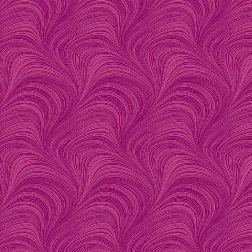Tonal fuchsia pink fabric with an all-over wave and brushstroke pattern, perfect as a quilt blender