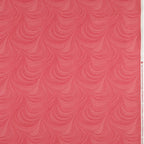 Tonal raspberry red fabric with an all-over wave and brushstroke pattern, perfect as a quilt blender