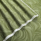Tonal sage green fabric with an all-over wave and brushstroke pattern, perfect as a quilt blender