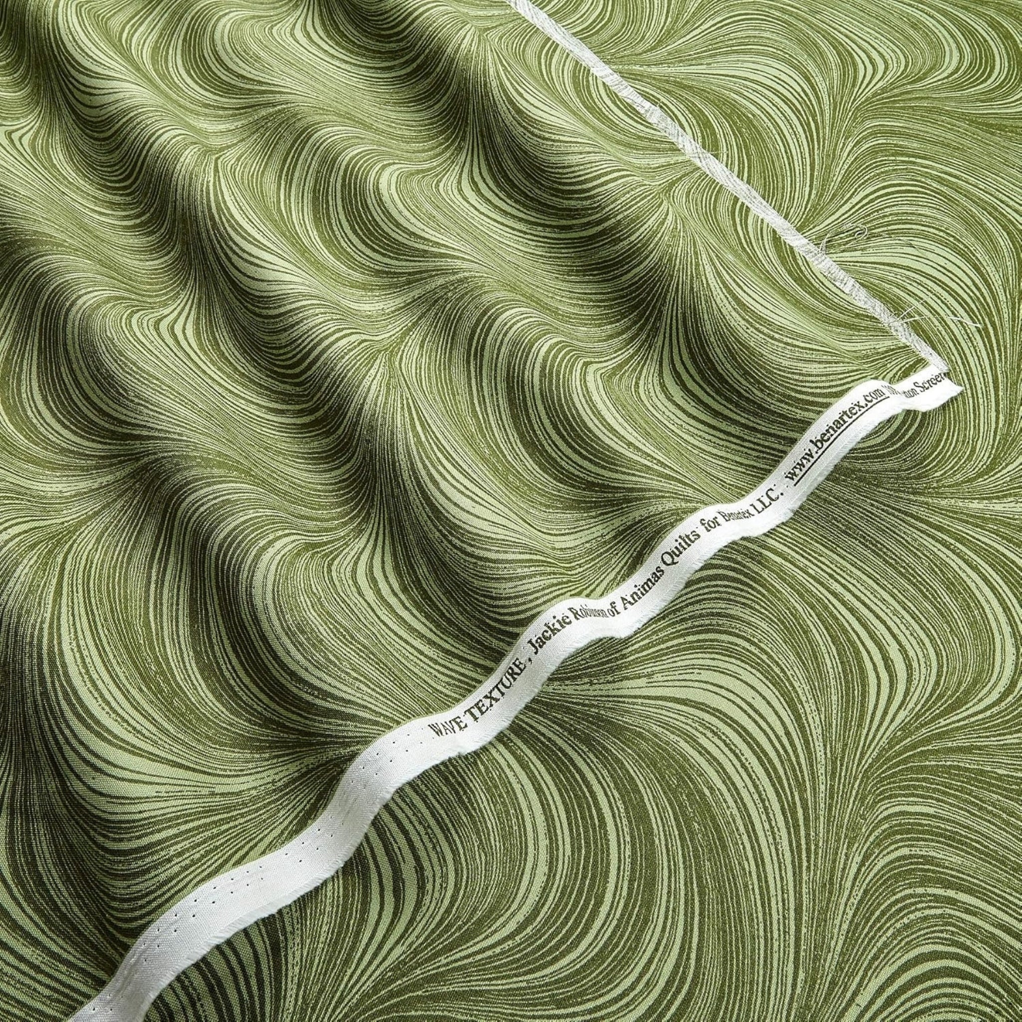 Tonal sage green fabric with an all-over wave and brushstroke pattern, perfect as a quilt blender