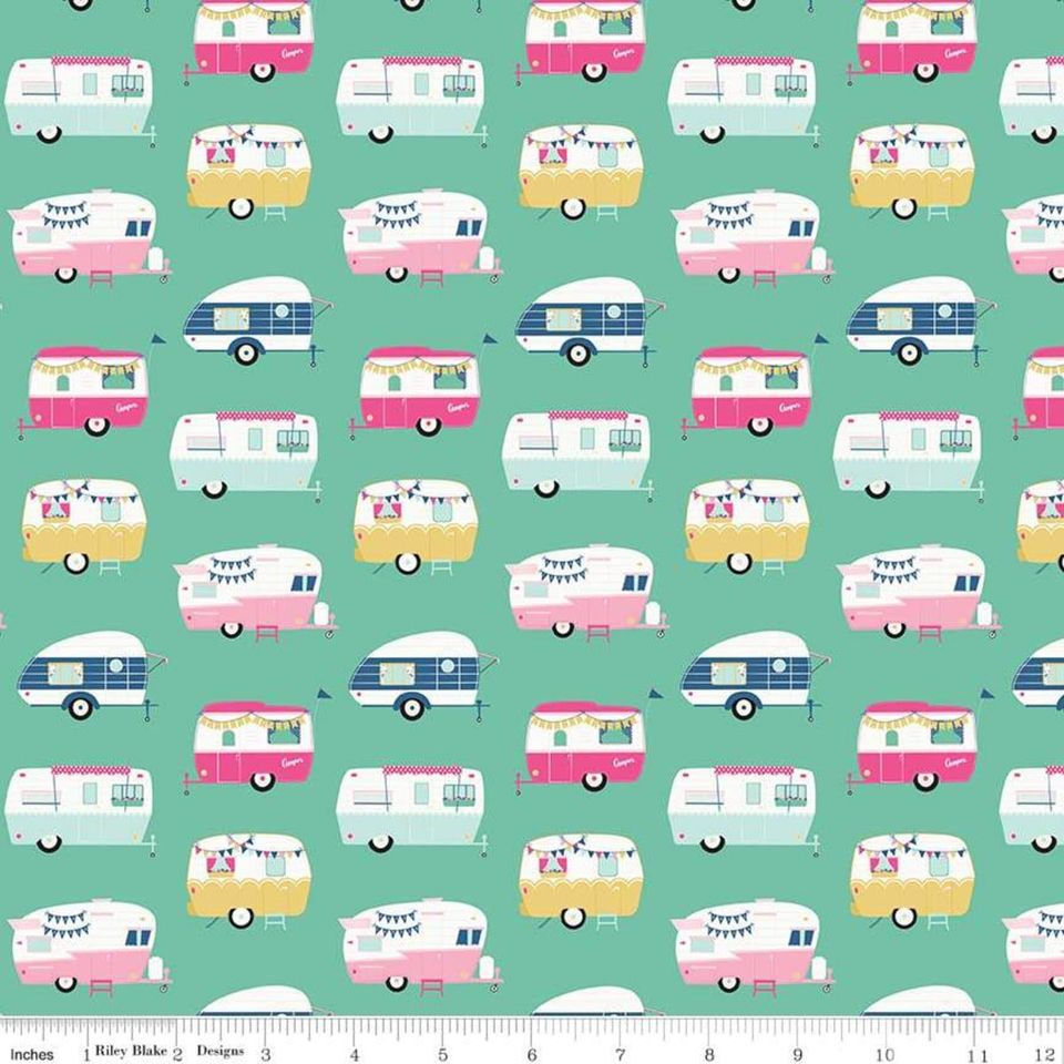 A fabric with a repeating pattern of vintage style campers in various colors including pink, blue, and yellow.