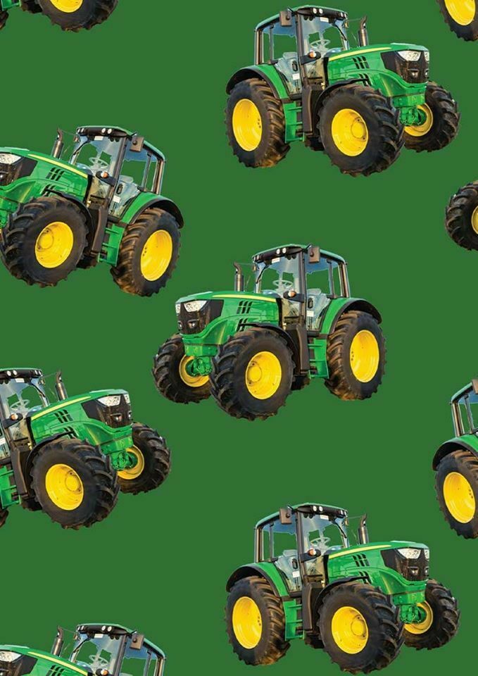 Large green tractor fabric on solid green background, perfect for boys' quilting projects for farm lovers